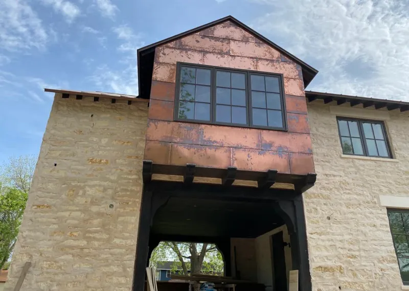 Copper metal panel facade on a stone building for Roof Repair in Plano