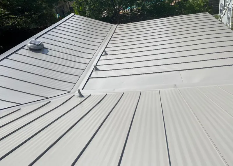 Solar attic fan installed on a metal roof for Roof Ventilation in Plano